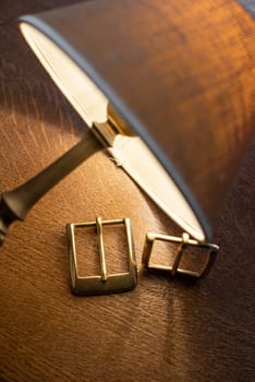 Set of decorative buckles made of metal on a wooden table