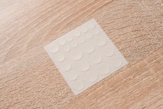 Set of round patches for acne on wooden background. Acne patches for the treatment of pimple and rosacea close-up. Facial rejuvenation cleansing cosmetology