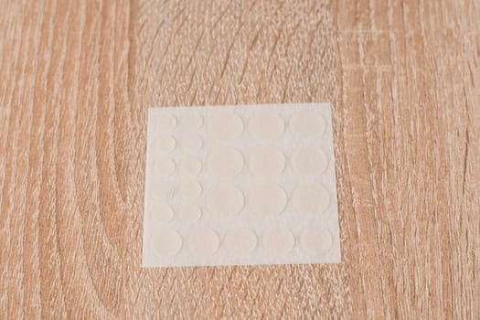 Set of round patches for acne on wooden background. Acne patches for the treatment of pimple and rosacea close-up. Facial rejuvenation cleansing cosmetology