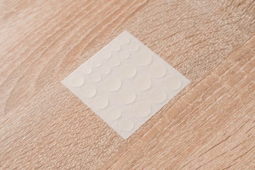 Set of round patches for acne on wooden background. Acne patches for the treatment of pimple and rosacea close-up. Facial rejuvenation cleansing cosmetology