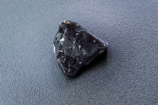 Obsidian rock. Volcanic material. Rough edges. Sharpest rock black background