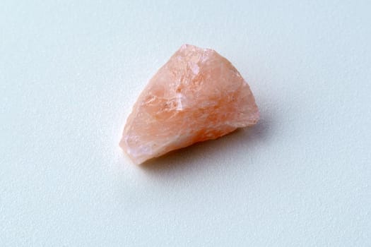 Rose quartz, stone silicate mineral. Rough, uncut, pinkish color isolated white background