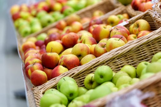 Green and red apples. Shelf with fruits on a farm market, selective focus