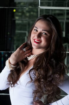 Image of beautiful smiling brunette in white dress, close-up