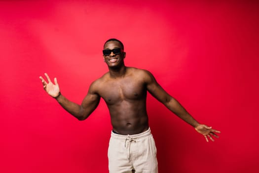 Like what you see. A handsome and muscular young man posing in a studio.