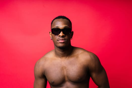 Like what you see. A handsome and muscular young man posing in a studio.