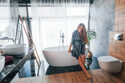 Beautiful young woman have free time at home in the bath.