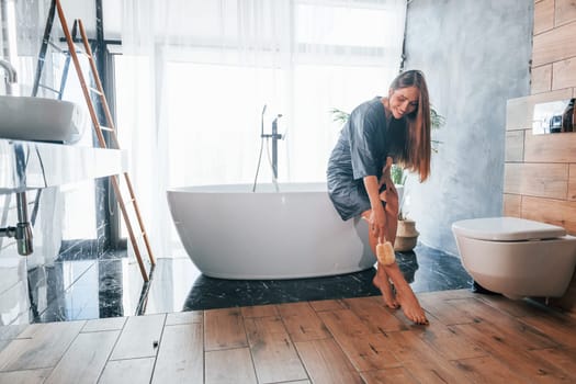 Beautiful young woman have free time at home in the bath.