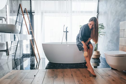 Beautiful young woman have free time at home in the bath.