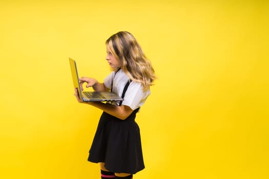 Little happy blonde kid girl 12-13 years laptop computer. Children lifestyle childhood concept.