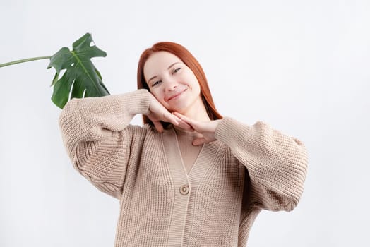 Happy beautiful caucasian woman smiling touching her face over white background, copy space