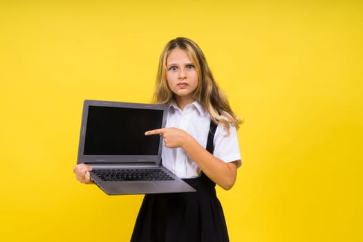 Little happy blonde kid girl 12-13 years laptop computer. Children lifestyle childhood concept.