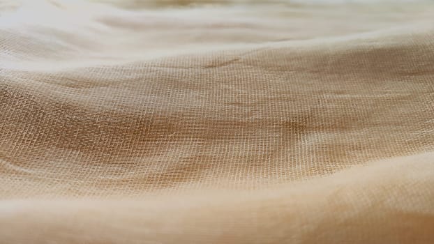 Abstract background and texture from yellow linen fabric, made from linen fiber