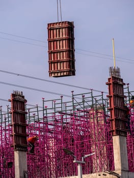 The pink scaffolding on the building under construction