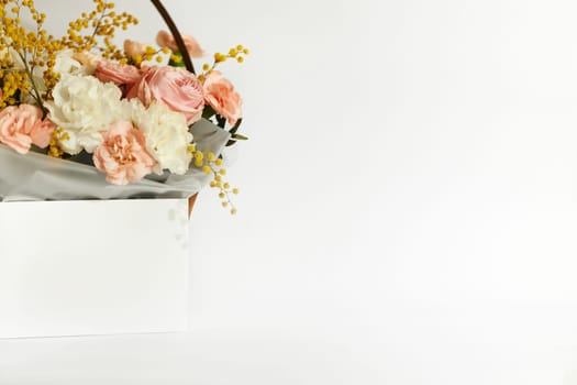 box with beautiful bouquet white and pink flowers on white background. Spring flowers. copy space