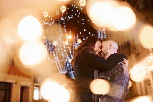 Happy multiracial couple together outdoors in the city celebrating New year.