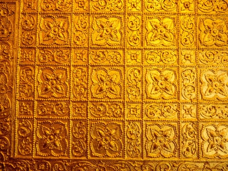 Beautiful Burmese art pattern motifs decorative design on the golden walls of the rooms in the temple