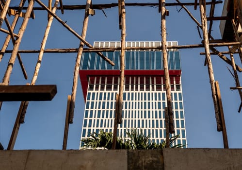 Temporary wooden pole for supports the concrete structure a building under construction