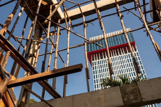 Temporary wooden pole for supports the concrete structure a building under construction