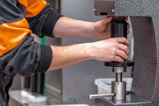 closed with the lid of beverage cans in an automatic capping machine in a brewery.