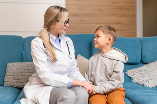 A family doctor examines a little boy at home. Pediatrician girl treats a child.