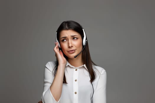 stressful frustrated female call center agent is consulting clients online. Call center, business people concept