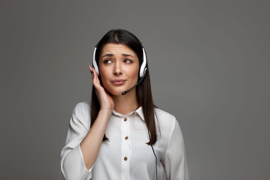 tired upset frustrated woman with headset is consulting clients online. Call center