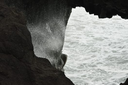 Scenic view of powerful ocean waves crashing on the rocks in Dyrholaey Cape Iceland