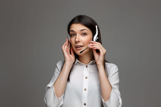 attentive woman with headphones and microphone is consulting clients online. Call center, business people concept