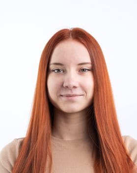 Passport photo of a real young woman with ginger red hair , isolated on white background. Document photo