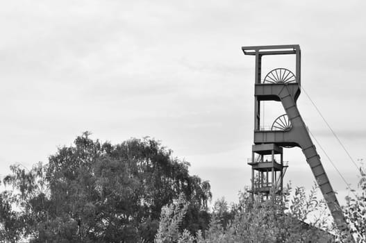 Grayscale shot of the winding tower of an old colliery in Essen, Ruhr area, NRW, Germany.