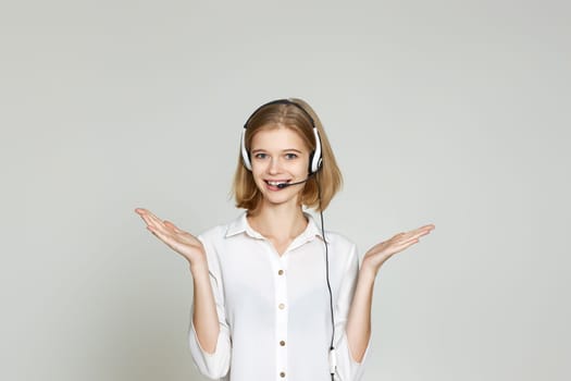 friendly blonde woman with headset is consulting clients online. Call center, business people concept