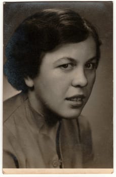 THE CZECHOSLOVAK SOCIALIST REPUBLIC - CIRCA 1960s: Retro photo shows young woman (studio portrait). Black and white vintage photography.