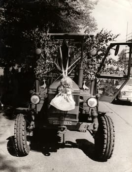 THE CZECHOSLOVAK SOCIALIST REPUBLIC - CIRCA 1970s: Retro photo shows tractor uses for rural wedding celebration. Black and white vintage photography.