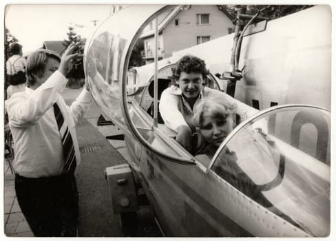 THE CZECHOSLOVAK SOCIALIST REPUBLIC - CIRCA 1970s: Retro photo shows the newlyweds sit in a small airplane. Black and white vintage photography.