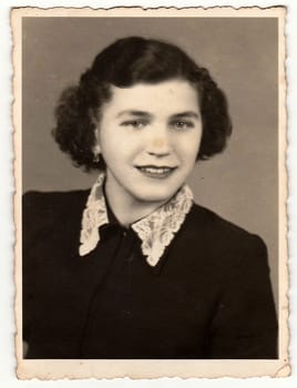 THE CZECHOSLOVAK SOCIALIST REPUBLIC - CIRCA 1950s: Retro photo shows young woman, studio portrait. Black and white vintage photography.