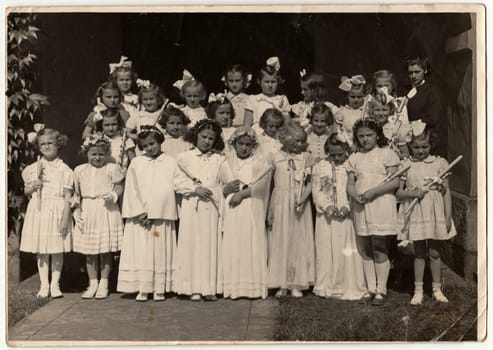 THE CZECHOSLOVAK SOCIALIST REPUBLIC - CIRCA 1950s: Retro photo shows girls and their first communion. Black and white vintage photography.