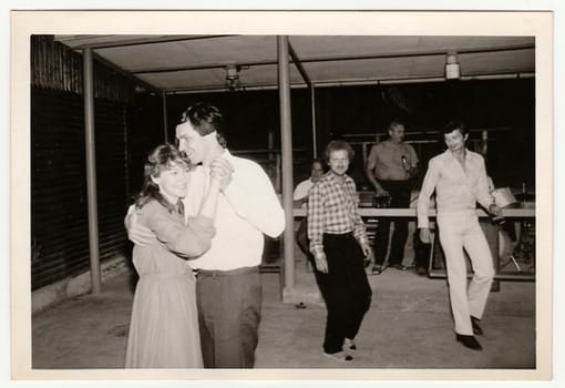 THE CZECHOSLOVAK SOCIALIST REPUBLIC - CIRCA 1970s: Retro photo shows people dance on rural celebration. Black and white vintage photography.