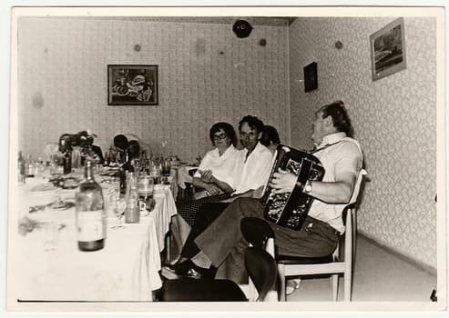 THE CZECHOSLOVAK SOCIALIST REPUBLIC - CIRCA 1970s: Retro photo shows people at the party. Black and white vintage photography.