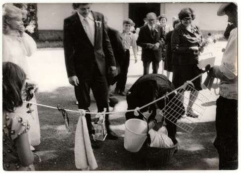 THE CZECHOSLOVAK SOCIALIST REPUBLIC - CIRCA 1970s: Retro photo shows wedding guests during rural wedding celebration. Black and white vintage photography.