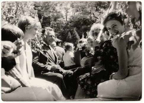 THE CZECHOSLOVAK SOCIALIST REPUBLIC - CIRCA 1970s: Retro photo shows people ride on rural wedding celebration. Black and white vintage photography.