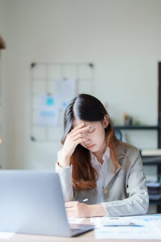 Portrait of sme business owner, man using computer and financial statements Anxious expression on expanding the market to increase the ability to invest in business.