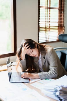 Portrait of sme business owner, man using computer and financial statements Anxious expression on expanding the market to increase the ability to invest in business.