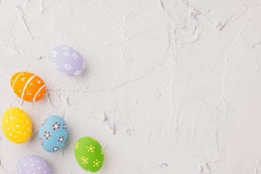 Happy Easter Day Concept. Top view holiday banner background web design white colorful easter eggs painted on cement background with empty copy space, celebration greeting card, overhead, template