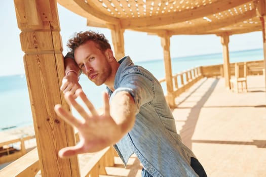 Young european man have vacation and enjoying free time on the beach of sea.