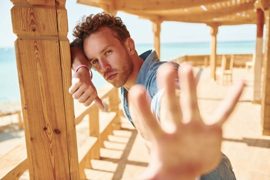 Young european man have vacation and enjoying free time on the beach of sea.