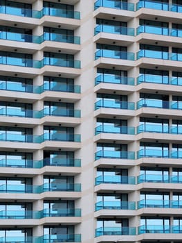 modern facade of a high-rise building with glass balconies for an architectural urban