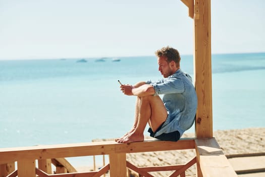Young european man have vacation and enjoying free time on the beach of sea.