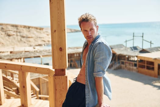 Young european man have vacation and enjoying free time on the beach of sea.