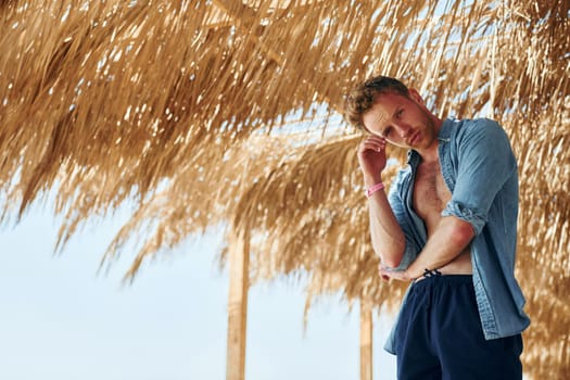 Young european man have vacation and enjoying free time on the beach of sea.